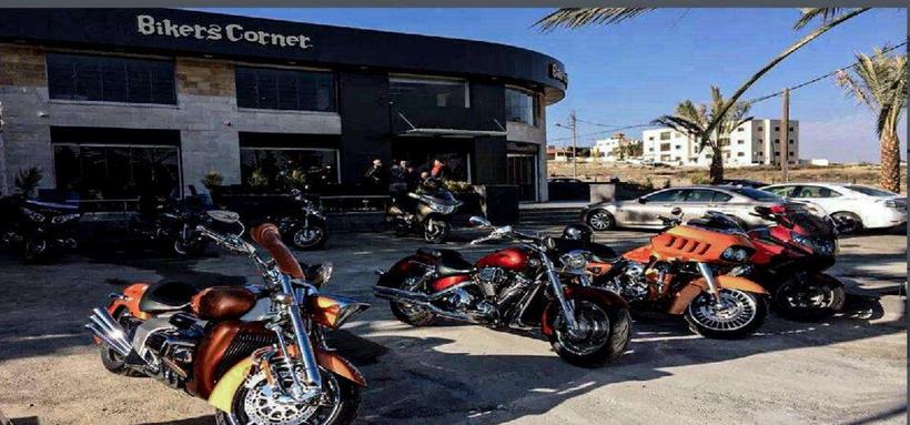 Bikers Corner Café stone shopfront with motorcycles parked outside, Amman