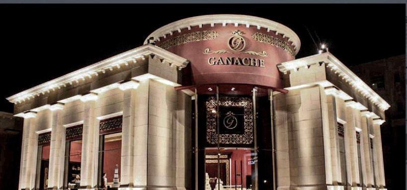 Ganache Patisserie illuminated neoclassical stone pavilion at night, Amman
