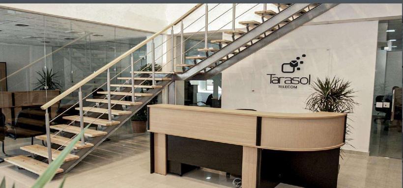 Tarasol Telecom headquarters — double-height workspace with suspended timber stair, Amman
